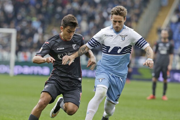 Palermo’s Paulo Dybala, left, and Lazio’s Lucas Biglia fight for the ball during a Serie A soccer match between Roma and Palermo, at Rome's Olympic Stadium, Sunday, Feb. 22, 2015. (AP Photo/Andrew Medichini)