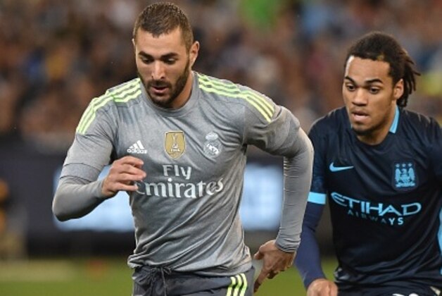 Real Madrid's Karim Benzema (L) vies for the ball with Manchester City's Jason Denayer (R) the International Champions Cup Australia football match between English Premier League team Manchester City and Spanish side Real Madrid in Melbourne on July 24, 2015. Real Madrid won the match 4-1. AFP PHOTO / Paul CROCK -- IMAGE RESTRICTED TO EDITORIAL USE - STRICTLY NO COMMERCIAL USE        (Photo credit should read PAUL CROCK/AFP/Getty Images)