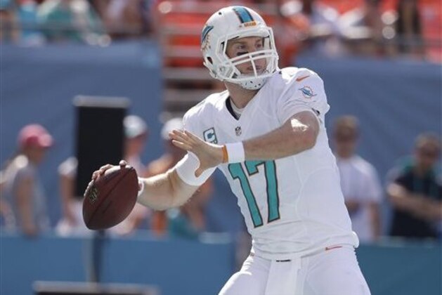 FILE - In this Dec. 28, 2014, file photo, Miami Dolphins quarterback Ryan Tannehill (17) looks to pass during the first half of an NFL football game against the New York Jets in Miami Gardens, Fla. Tannehill stopped the Dolphins' revolving door at quarterback, and on Monday, May 18, 2015, they rewarded him. Tannehill signed a $77.7 million, four-year extension that keeps him under contract through 2020.  (AP Photo/Lynne Sladky, File)