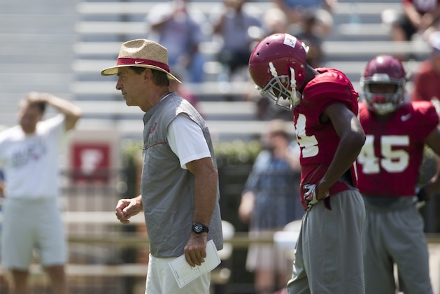 Alabama coach Nick Saban, front left, runs drills during an NCAA college football practice, Sunday, Aug. 9, 2015, in Tuscaloosa, Ala. (AP Photo/Brynn Anderson)