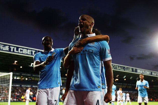 WEST BROMWICH, ENGLAND - AUGUST 10:  Vincent Kompany of Manchester City (4) celebrates as he scores their third goal during the Barclays Premier League match between West Bromwich Albion and Manchester City at The Hawthorns on August 10, 2015 in West Bromwich, England.  (Photo by Michael Steele/Getty Images)