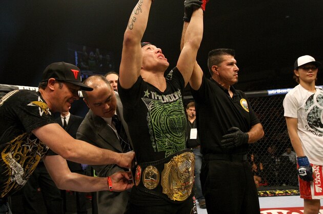 SAN DIEGO - DECEMBER 17:  Cris 'Cyborg' Santos (center) has the Strikeforce women's featherweight title placed around her waist as she is declared the winner in her fight with Hiroko Yamanaka (right) during the Strikeforce event at the Valley View Casino Center on December 17, 2011 in San Diego, California.  (Photo by Josh Hedges/Forza LLC/Forza LLC via Getty Images)