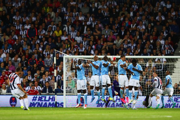 WEST BROMWICH, ENGLAND - AUGUST 10:  Rickie Lambert of West Bromwich Albion (L) shoots past the Manchester City wall from a free kick during the Barclays Premier League match between West Bromwich Albion and Manchester City at The Hawthorns on August 10, 2015 in West Bromwich, England.  (Photo by Michael Steele/Getty Images)
