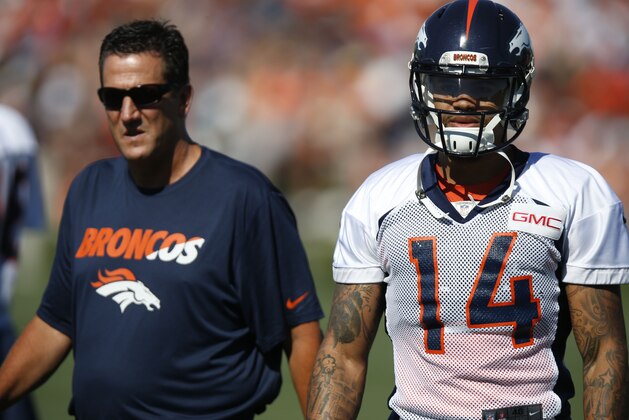 Denver Broncos wide receiver Cody Latimer (14), front, confers with quarterbacks coach Greg Knapp at the team's NFL football training camp Friday, July 31, 2015, in Englewood, Colo. (AP Photo/David Zalubowski)