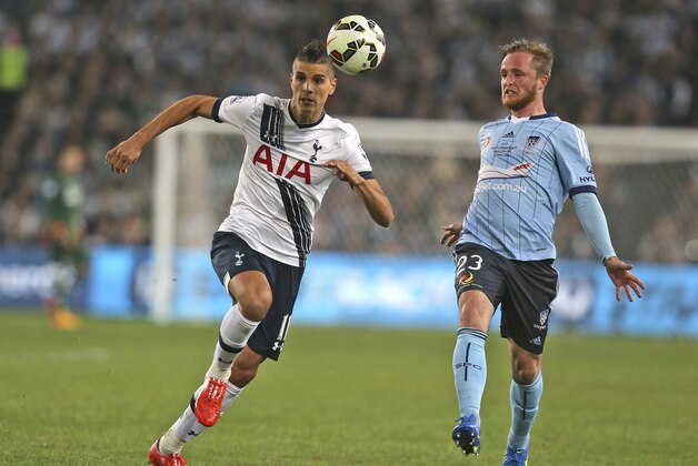 Tottenham Hotspur player Erik Lamela, left, and Sydney F.C player Rhyan Grant race for the ball during their friendly match in Sydney, Australia, Saturday, May 30, 2015. (AP Photo/Glenn Nicholls)
