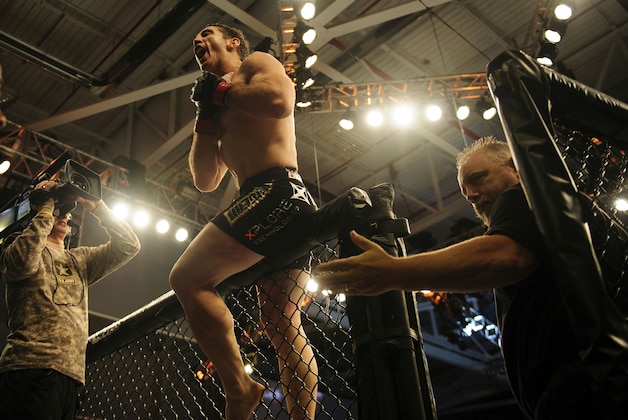 Nov 6, 2013; Fort Campbell, KY, USA; Tim Kennedy (red gloves) reacts to his win against Rafael Natal (not pictured) in the middleweight bout during UFC Fight for the Troops at Fort Campbell. Mandatory Credit: Joshua Lindsey-USA TODAY Sports