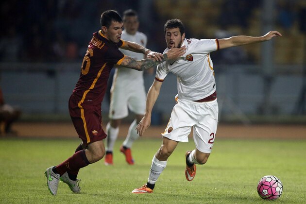AS Roma's Alicio Romagnoli, left, competes against teammate Mattia Destro, right, during their exhibition soccer match at Gelora Bung Karno stadium in Jakarta, Indonesia, Saturday, July 25, 2015. (AP Photo/Achmad Ibrahim)