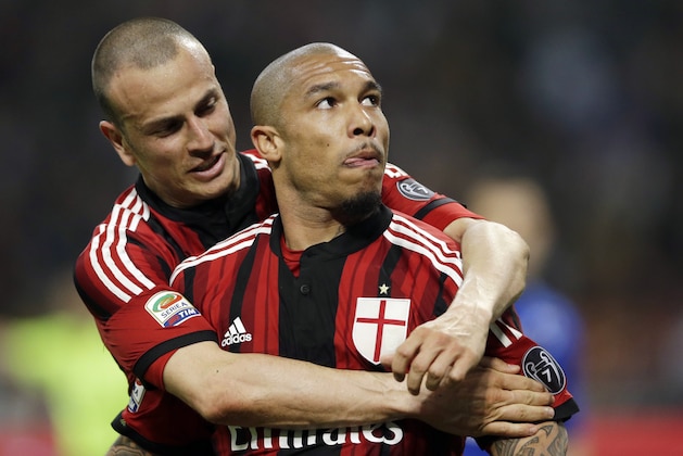 AC Milan's Nigel de Jong, right, celebrates with his teammate Luca Antonelli after Sampdoria's Daniel Duncan scored an own goal, during a Serie A soccer match between AC Milan and Sampdoria, at the San Siro stadium in Milan, Italy, Sunday, April 12, 2015. (AP Photo/Luca Bruno)