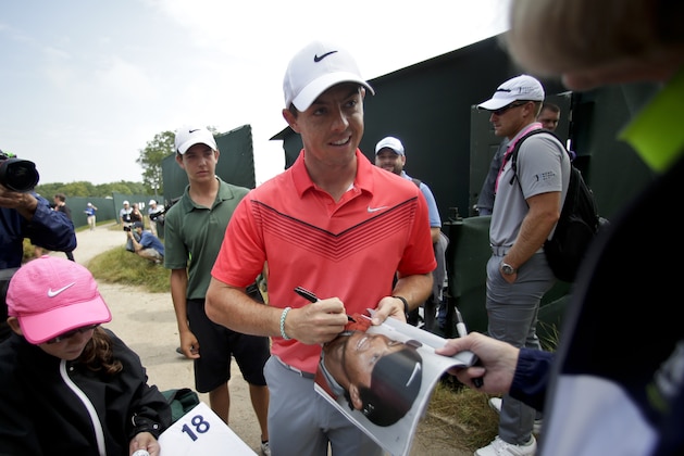 Rory McIlroy, of Northern Ireland, signs autographs after a practice round for the PGA Championship golf tournament at Whistling Straits Golf Course on Monday, Aug. 10, 2015 in Haven, Wis. (AP Photo/Chris Carlson)