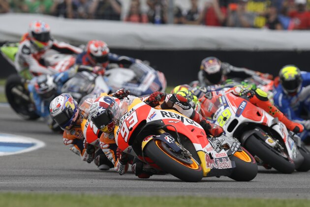 Marc Marquez, front, of Spain, takes a turn on his way to winning the Indianapolis Grand Prix at Indianapolis Motor Speedway in Indianapolis, Sunday, Aug. 9, 2015.  (AP Photo/Michael Conroy)
