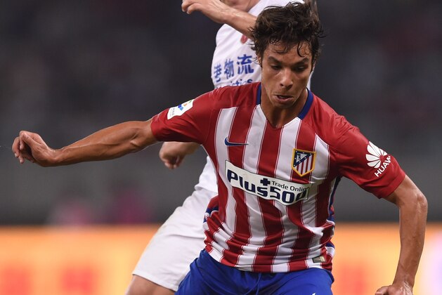 Atletico Madrid's midfielder Oliver Torres (front) and Shanghai's Argentinian forward Dario Conca vie for the ball during a friendly football match between Shanghai SIPG and Atletico Madrid in Shanghai on August 4, 2015. AFP PHOTO / JOHANNES EISELE        (Photo credit should read JOHANNES EISELE/AFP/Getty Images)