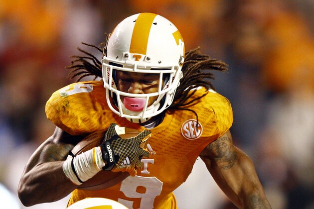Tennessee wide receiver Von Pearson (9) runs for yardage as he is hit by Alabama defensive back Nick Perry (27) in the third quarter of an NCAA college football game Saturday, Oct. 25, 2014, in Knoxville, Tenn. (AP Photo/Wade Payne)
