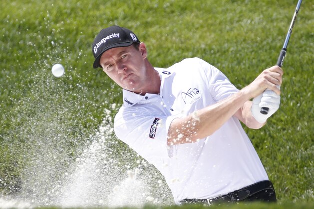 Jimmy Walker hits out of the bunker on the second hole during the final round of the Quicken Loans National golf tournament at the Robert Trent Jones Golf Club in Gainesville, Va., Sunday, Aug. 2, 2015.  (AP Photo/Steve Helber)