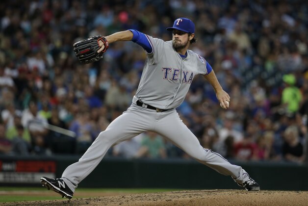 Texas Rangers starting pitcher Cole Hamels in action against the Seattle Mariners in a baseball game  Friday, Aug. 7, 2015, in Seattle. (AP Photo/Elaine Thompson)