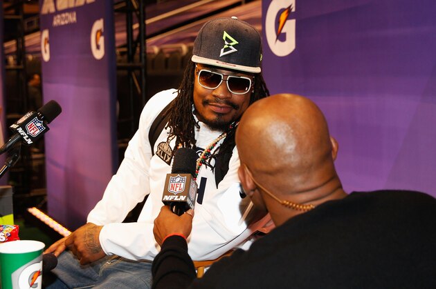 PHOENIX, AZ - JANUARY 27:  Marshawn Lynch #24 of the Seattle Seahawks talks with NFL Network personality Deion Sanders at Super Bowl XLIX Media Day Fueled by Gatorade inside U.S. Airways Center on January 27, 2015 in Phoenix, Arizona.  (Photo by Christian Petersen/Getty Images)