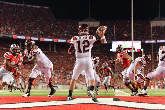 COLUMBUS, OH - SEPTEMBER 6:  Quarterback Michael Brewer #12 of the Virginia Tech Hokies passes against the Ohio State Buckeyes at Ohio Stadium on September 6, 2014 in Columbus, Ohio.  (Photo by Jamie Sabau/Getty Images)