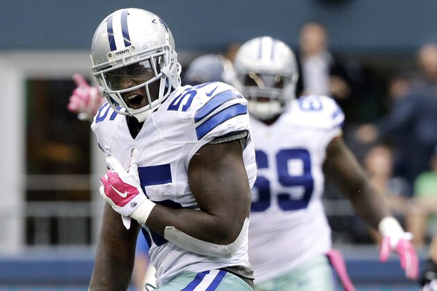 FILE - In this Oct. 12, 2014, file photo, Dallas Cowboys middle linebacker Rolando McClain celebrates after he intercepted a pass late in the second half of an NFL football game against the Seattle Seahawks in Seattle. The Cowboys are bringing back McClain after the former top 10 pick revived his career with a solid season in Dallas.(AP Photo/Elaine Thompson, File)