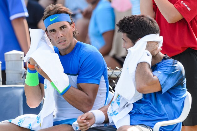 MONTREAL, ON - AUGUST 10:  Rafael Nadal of Spain and teammate Fernando Verdasco of Spain dry off during day one of the Rogers Cup at Uniprix Stadium in his doubles match against Tomas Berdych of the Czech Republic and Jack Sock of the USA on August 10, 2015 in Montreal, Quebec, Canada.  (Photo by Minas Panagiotakis/Getty Images)