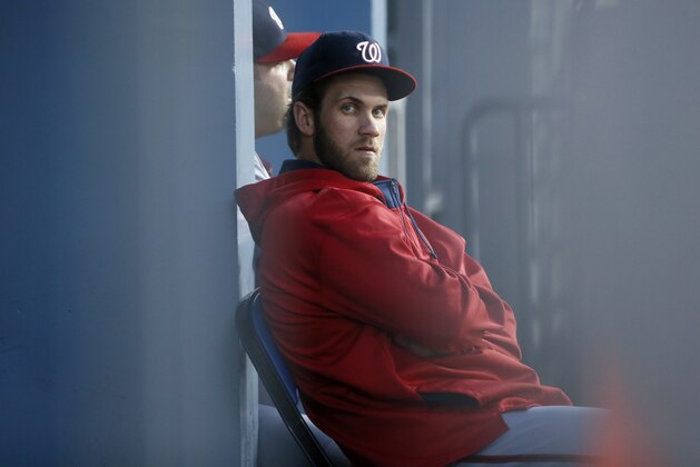 Washington Nationals right fielder Bryce Harper sits in the dugout while not in the starting line up against the Los Angeles Dodgers during the second inning of a baseball game, Tuesday, Aug. 11, 2015, in Los Angeles. (AP Photo/Danny Moloshok)