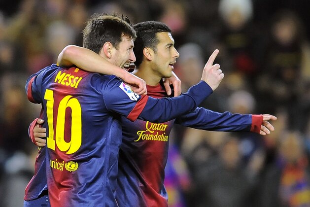 Barcelona's Lionel Messi from Argentina, left, celebrates with his fellow teammate Pedro after scoring against Osasuna during their Spanish League soccer match, at Camp Nou stadium in Barcelona, Spain, Sunday, Jan. 27, 2013. Barcelona won the match 5-1. (AP Photo/Alvaro Barrientos)