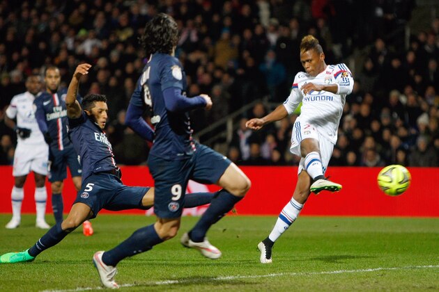 Lyon's Cameroonian forward Clinton N'Jie, right, scores past Paris Saint-Germain Edinson Cavani, center, and Marcos Aoas Correa during the League One soccer match between Lyon and Paris Saint-Germain at the Gerland Stadium, in Lyon, central France, Sunday Feb. 8, 2015. (AP Photo/Claude Paris)