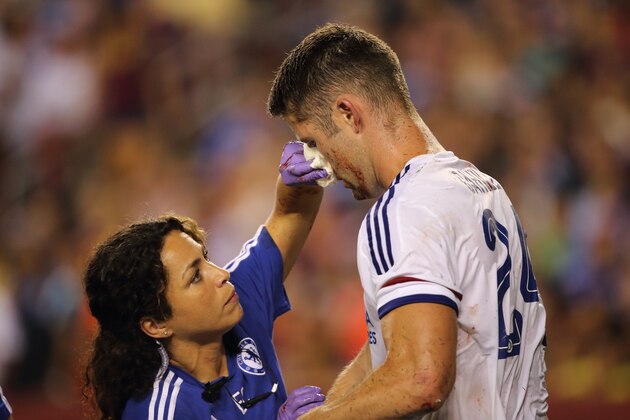 LANDOVER, MD - JULY 28:  Chelsea first-team doctor Eva Carneiro attends to Gary Cahill of Chelsea who suffered a bloody nose following scoring the goal which tied the game 2-2 during the International Champions Cup match between Barcelona and Chelsea at FedExField on July 28, 2015 in Landover, Maryland.  (Photo by Matthew Ashton - AMA/Getty Images)