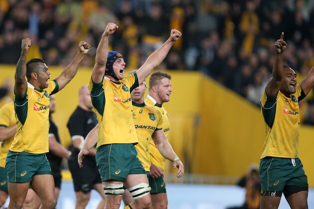 Australian players celebrate their win over New Zealand after their Rugby Championship match in Sydney, Australia, Saturday, Aug. 8, 2015. Australia won the match 27-19. (AP Photo/Rick Rycroft)