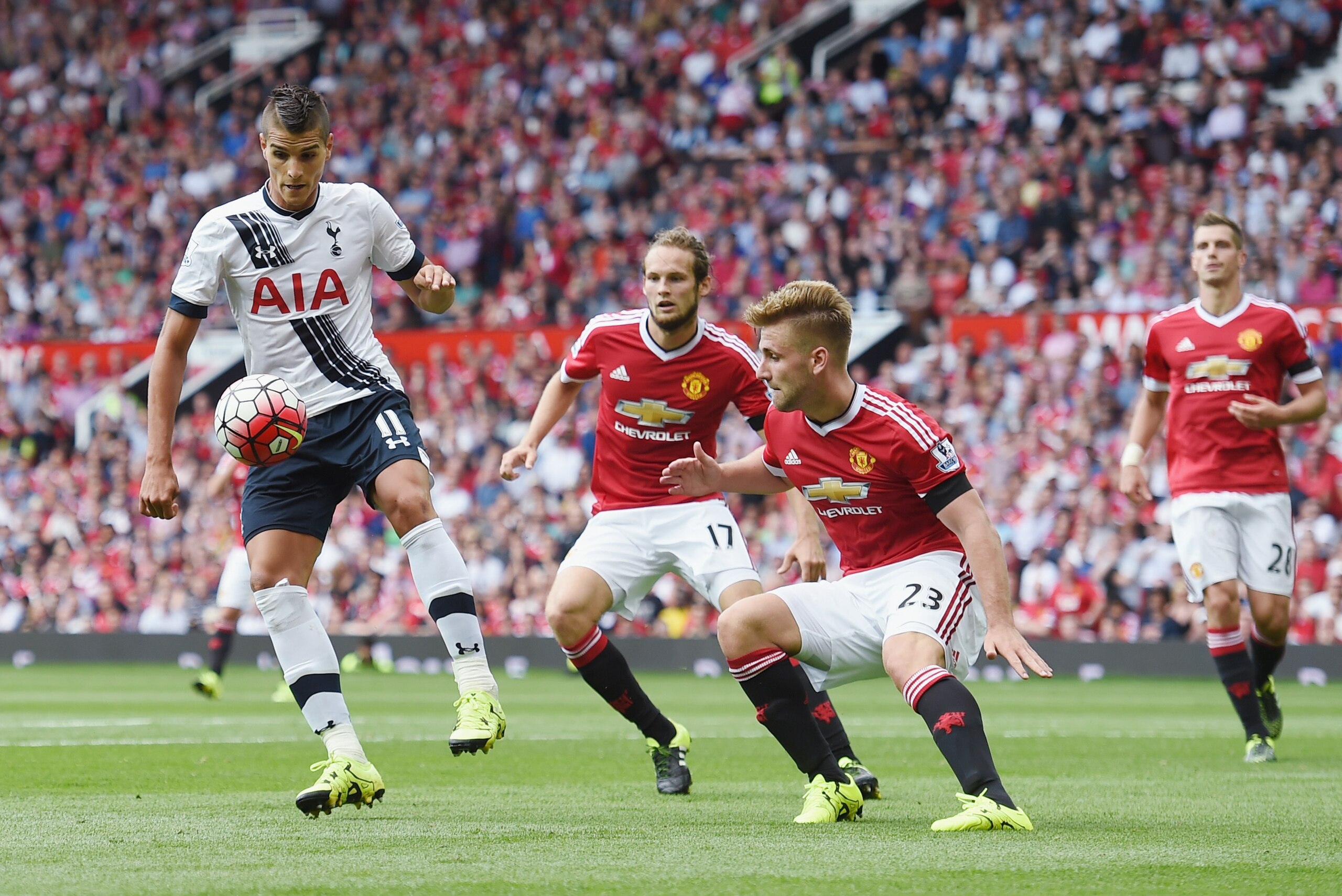 MANCHESTER, ENGLAND - AUGUST 08: Erik Lamela of Tottenham in action with Daley Blind and Luke Shaw of Manchester United during the Barclays Premier League match between Manchester United and and Tottingham Hotspur at Old Trafford, Manchester.  (Photo by Michael Regan/Getty Images)