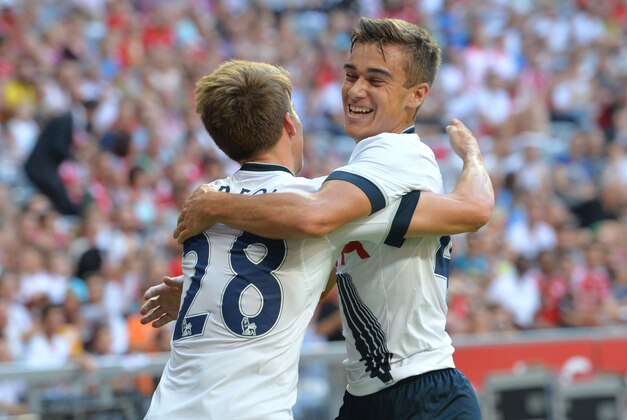 Tottenham's scorer Tom Carroll, left, and Harry Winks celebrate a goal, during the friendly soccer match between AC Milan and Tottenham Hotspur, in the Allianz Arena stadium in Munich, southern Germany, Wednesday, Aug. 5, 2015. (AP Photo/Kerstin Joensson)