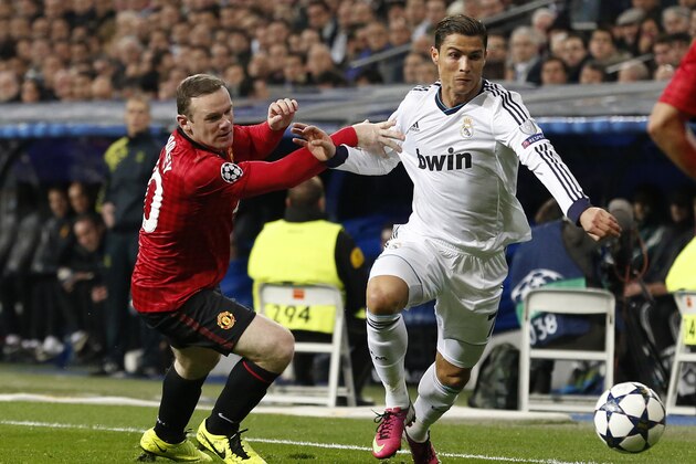 Real Madrid's Portuguese forward Cristiano Ronaldo (R) vies with Manchester United's striker Wayne Rooney during the UEFA Champions League round of 16 first leg football match Real Madrid CF vs Manchester United FC at the Santiago Bernabeu stadium in Madrid on February 13, 2013.  AFP PHOTO / CESAR MANSO        (Photo credit should read CESAR MANSO/AFP/Getty Images)