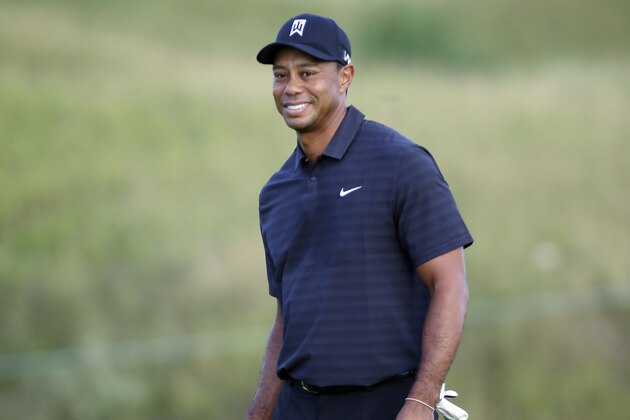 Tiger Woods smiles as he plays the 10th hole during a practice round for the PGA Championship golf tournament Wednesday, Aug. 12, 2015, at Whistling Straits in Haven, Wis. (AP Photo/Brynn Anderson)