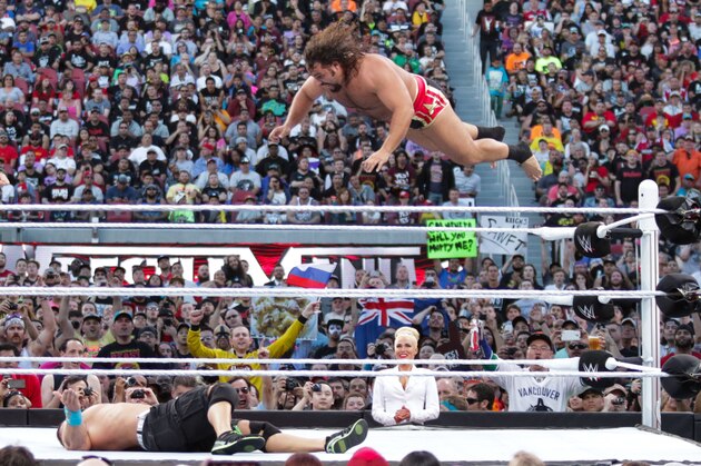 Rusev flies through the air against opponent John Cena  at Wrestlemania XXXI, on Sunday, March 29, 2015 in Santa Clara, CA. 2015 marks the first year Wrestlemania will be held in the San Francisco Bay Area, being made available to viewers in 177 countries via the WWE Network. (Don Feria/AP Images for WWE)