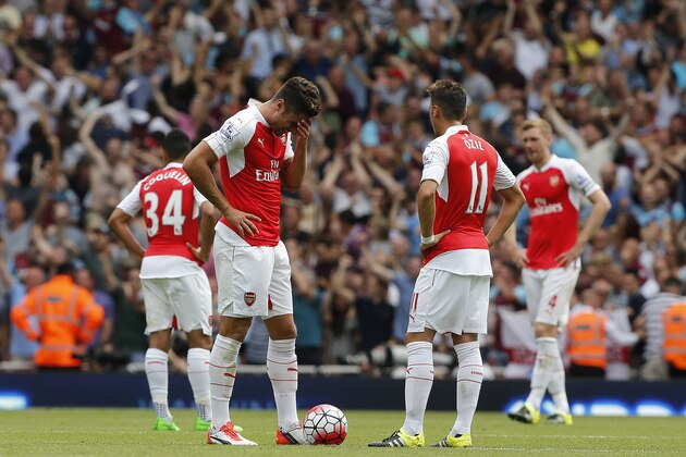 Arsenal players react after West Ham scored  during the English Premier League soccer match between Arsenal and West Ham at the Emirates stadium in London, Sunday, Aug. 9, 2015.(AP Photo/Frank Augstein)