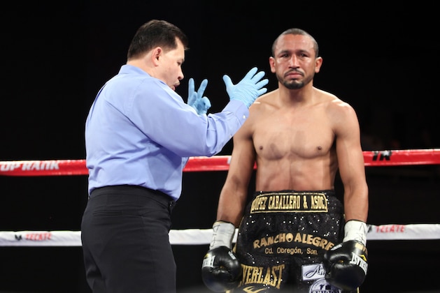 WBO Featherweight Champion Orlando Salido receives a mandatory count after a knockdown against Miguel Angel Garcia at the Theater at Madison Square Garden on Saturday, January 19, 2013 in New York City. Garcia won the title via Technical Decision in the 8th round after an accidental head butt broke his nose.  Garcia was declared the winner on the scorecards. (AP Photo/Gregory Payan)