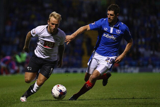 PORTSMOUTH, ENGLAND - AUGUST 12:  Danny Hollands of Portsmouth tries to tackle Alex Pearce of Derby County during the Capital One Cup First Round match between Portsmouth v Derby County at Fratton Park on August 12, 2015 in Portsmouth, England.  (Photo by Ian Walton/Getty Images)