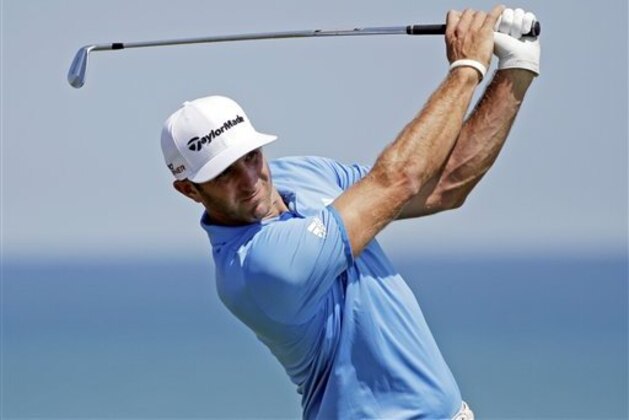 Dustin Johnson watches his shot on the third hole during a practice round for the PGA Championship golf tournament Wednesday, Aug. 12, 2015, at Whistling Straits in Haven, Wis. (AP Photo/Jae Hong)