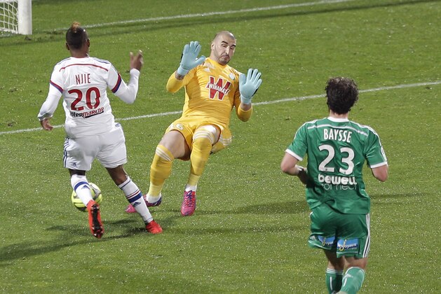 Lyon's Clinton Mua Njie, left, kicks the ball in front of Saint-Etienne's goalkeeper Kevin Theophile Catherine, right, during their French League One soccer match in Lyon, central France, Sunday, April 19, 2015. (AP Photo/Laurent Cipriani)