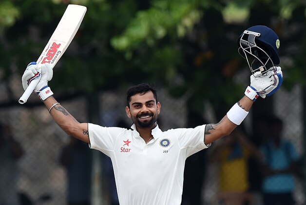 Indian cricket team captain Virat Kohli raises his bat after reaching a century (100 Runs) during the second day of the opening Test match between Sri Lanka and India at the Galle International Cricket Stadium in Galle on August 13, 2015. AFP PHOTO/ Ishara S. KODIKARA        (Photo credit should read Ishara S.KODIKARA/AFP/Getty Images)