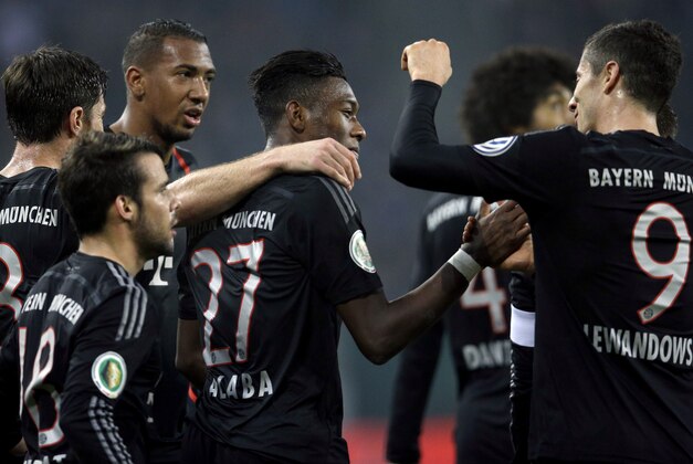 Bayern's David Alaba from Austria, center, celebrates after scoring his side's second goal during the German soccer cup second round match between Hamburger SV and FC Bayern Munich at the Imtech Arena Stadium in Hamburg, Germany, Wednesday, Oct. 29, 2014. (AP Photo/Michael Sohn)