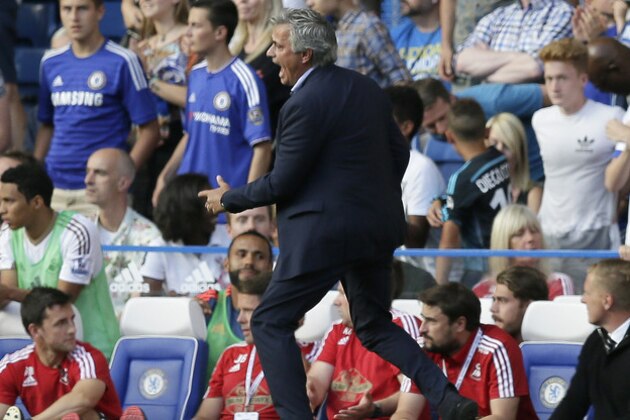 Chelsea manager Jose Mourinho shouts across the pitch as Chelsea’s Eden Hazard lies apparently injured following a foul during the English Premier League soccer match between Chelsea and Swansea City at Stamford Bridge, London, Saturday Aug. 8, 2015. (AP Photo/Tim Ireland)