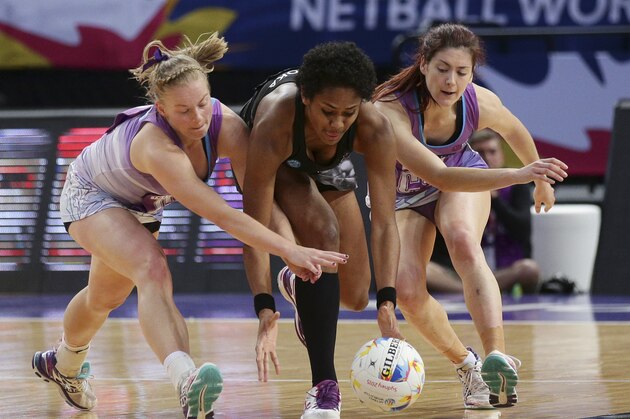 Fiji's Episake Gaunavinaka Kahatoka, center, races with Scotland's Gemma Sole, right, and Claire Brownie for the ball during their Netball World Cup in Sydney, Australia, Thursday, Aug. 13, 2015. (AP Photo/Rob Griffith)