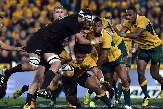 New Zealand All Blacks Samuel Whitelock (L) tackles Australia's Tatafu Polota-Nau (C) during the Bledisloe Cup Test match as part of the Rugby Championship in Sydney on August 8, 2015. AFP PHOTO / SAEED KHAN 
-- IMAGE RESTRICTED TO EDITORIAL USE - STRICTLY NO COMMERCIAL USE        (Photo credit should read SAEED KHAN/AFP/Getty Images)