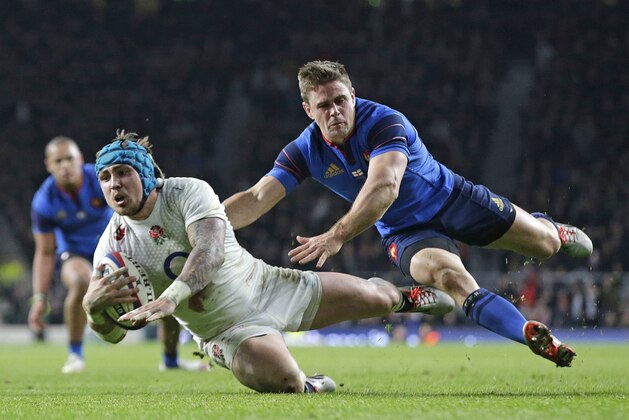 FILE - In this Saturday, March 21, 2015 file photo England’s Jack Nowell, left, goes over to score a try during the Six Nations rugby union match between England and France at Twickenham stadium in London. (AP Photo/Alastair Grant, File)