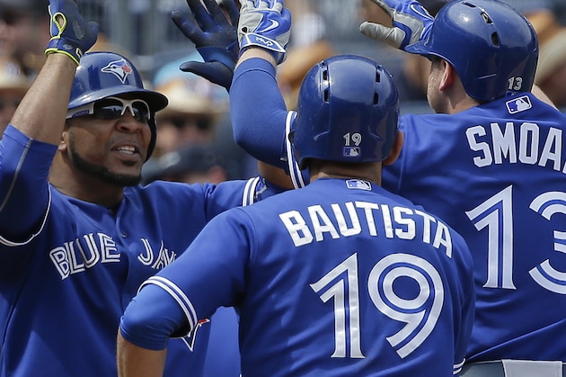 Toronto Blue Jays' Edwin Encarnacion, left, greets Justin Smoak (13) and Jose Bautista (19) after Smoak hit a grand slam home run against the New York Yankees during the sixth inning of a baseball game, Saturday, Aug. 8, 2015, in New York. (AP Photo/Julie Jacobson)