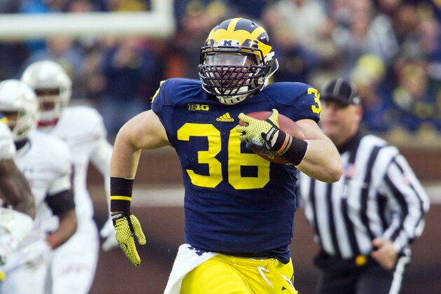 Michigan fullback Joe Kerridge (36) rushes on a fake punt play in the first quarter of an NCAA college football game against Maryland in Ann Arbor, Mich., Saturday, Nov. 22, 2014. (AP Photo/Tony Ding)