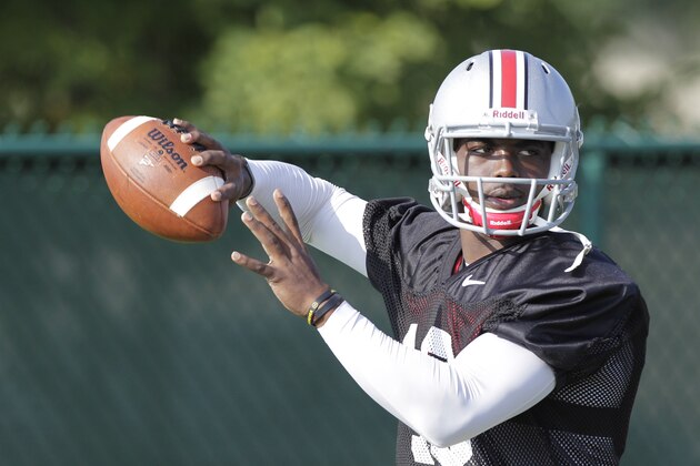 FILE - This Saturday, Aug. 9, 2014, file photo shows Ohio State quarterback J.T. Barrett throwing a pass during an NCAA college football practice in Columbus, Ohio. Barrett, a redshirt freshman who’s never taken a collegiate snap, is set to start when the Buckeyes open their season on Aug. 30 against Navy. Braxton Miller, a two-time Big Ten player of the year, tore the labrum of his (right) throwing shoulder on an unrushed, seven-yard pass on Monday. (AP Photo/Jay LaPrete, File)
