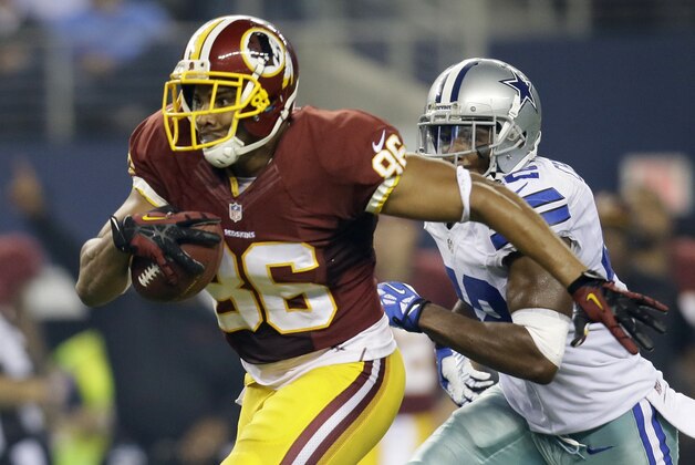 Washington Redskins tight end Jordan Reed (86) finds running room after grabbing a pass from quarterback Robert Griffin III as Dallas Cowboys free safety Barry Church (42) gives chase in the first half of an NFL football game, Sunday, Oct. 13, 2013, in Arlington, Texas.(AP Photo/Tim Sharp)