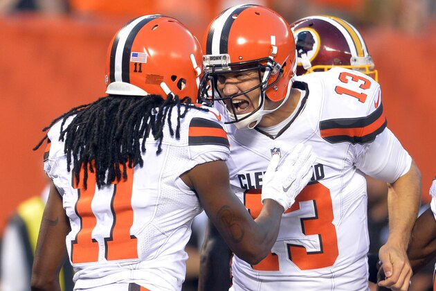 Cleveland Browns quarterback Josh McCown (13) celebrates with Travis Benjamin (11) after a 2-yard touchdown by Benjamin during the first quarter of an NFL preseason football game, Thursday, Aug. 13, 2015, in Cleveland. (AP Photo/David Richard)