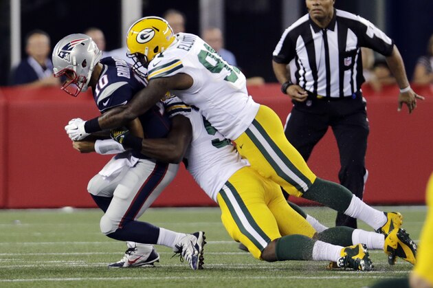 Green Bay Packers linebackers Jayrone Elliott (91) and Andy Mulumba, below, sack New England Patriots quarterback Jimmy Garoppolo (10) in the first half of an NFL preseason football game Thursday, Aug. 13, 2015, in Foxborough, Mass. (AP Photo/Charles Krupa)
