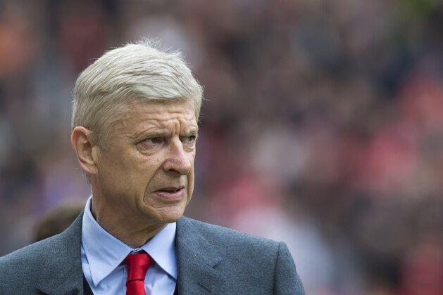 Arsenal's manager Arsene Wenger takes to the touchline before his team's English Premier League soccer match between Manchester United and Arsenal at Old Trafford Stadium, Manchester, England, Sunday, May 17, 2015. (AP Photo/Jon Super)